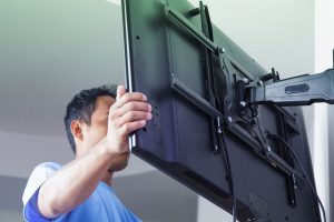 Man mounting a tv